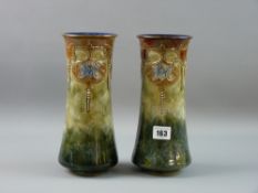 A PAIR OF ROYAL DOULTON STONEWARE VASES, tall cylindrical shape with floral relief decoration on a