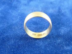 A TWENTY TWO CARAT GOLD WIDE WEDDING BAND, 3.5 grms