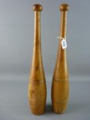 A PAIR OF WOODEN INDIAN TRAINING CLUBS, 48 cms long