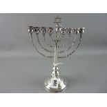 A SILVER JEWISH MENORAH, 24 cms high on a rose decorated circular base, 6.4 troy ozs with 800 mark