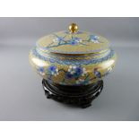 A 20th CENTURY CLOISONNE BOWL AND COVER on a carved wooden stand, decorated with prunus blossom