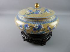 A 20th CENTURY CLOISONNE BOWL AND COVER on a carved wooden stand, decorated with prunus blossom