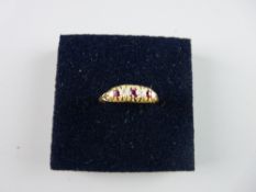 AN UNMARKED GOLD DRESS RING having three small rubies and two diamonds, 3 grms total