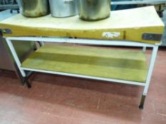 *A WOODEN BUTCHER'S BLOCK, 150 x 60 cms set on a metallic table with wooden base shelf