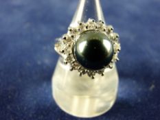 AN EIGHTEEN CARAT WHITE GOLD DRESS RING having a large dark pearl cluster with sixteen surrounding