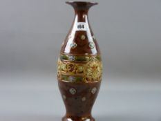 A ROYAL DOULTON HIGH FIRED STONEWARE VASE of baluster form with flared rim, having a floral relief