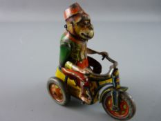 AN ARNOLD TINPLATE MONKEY ON A TRIKE, colourful clockwork German manufactured toy, nicely