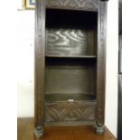 A REPRODUCTION ANTIQUE STYLE BOOKCASE, carved decoration to front with two open shelves and lower