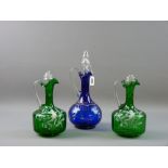 A PAIR OF MARY GREGORY GREEN GLASS DECANTERS decorated with a winged cherub amongst flora, (stoppers