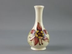 A MOORCROFT 'COLUMBINE' BOTTLE SHAPED VASE, 16 cms high, decorated on a cream ground, impressed