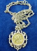 A NINE CARAT GOLD NECK CHAIN AND SOVEREIGN PENDANT, triple link chain, 10 grms, having a scrolled