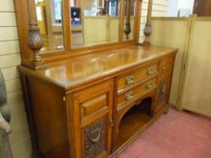 A CIRCA 1900 OAK MIRRORBACK SIDEBOARD with inverted block moulded cornice canopy on acanthus