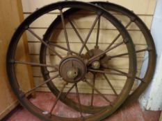 A PAIR OF VICTORIAN CAST IRON FARMING IMPLEMENT WHEELS with iron spokes, 74 cms diameter