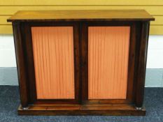 VICTORIAN ROSEWOOD TWO DOOR CREDENZA with fabric lined doors and columnal supports, 122cms wide