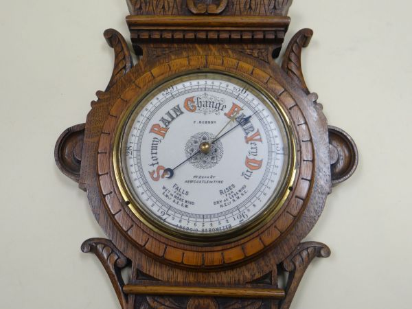 AN OAK ENCASED BAROMETER & THERMOMETER SET the case heavily carved with fluted pillars and having - Image 2 of 2