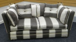 A MODERN KNOWLE SETTEE in striped upholstery and with drop ends
