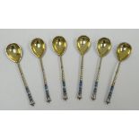 A SET OF SIX RUSSIAN SILVER CHAMPLEVE ENAMEL COFFEE SPOONS with floral and foliate decoration to the