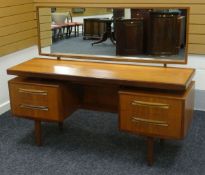 A GOOD G-PLAN DRESSING TABLE having a pair of flanking two drawers to the hidden jewellery slide and