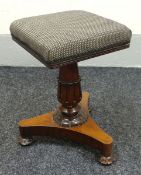 A ROSEWOOD MUSIC STOOL revolving on a decorative columnal support and with shaped triangular base