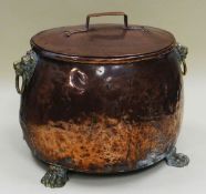 A GOOD COPPER AND BRASS LIDDED COAL BOX having the body of copper and with brass lion head handles