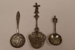 THREE DECORATIVE SPOONS comprising a castor spoon with decorative openwork to the circular bowl,