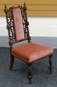 A SEMI-UPHOLSTERED NURSING CHAIR in highly-decorative frame work and with pink stuff-over seat and