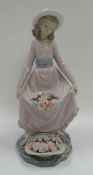 A BOXED LLADRO FIGURE OF A FLOWER PICKER collecting flowers in her dress with basket, 25cms high