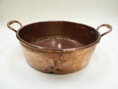 A BENHAM & SON COPPER CHEESE PAN with elevated twin handles, 49cms diam