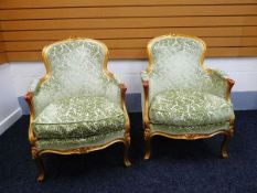 A PAIR OF REPRODUCTION ELBOW CHAIRS with gilded effect, and having green foliate felt upholstery