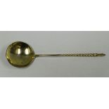 A RUSSIAN SILVER GILT SPOON with floral engraved bowl and monogram and having a spiral stem,