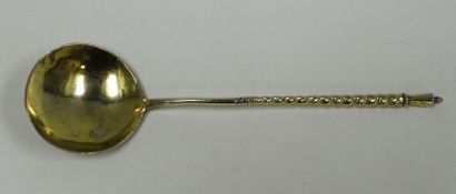 A RUSSIAN SILVER GILT SPOON with floral engraved bowl and monogram and having a spiral stem,