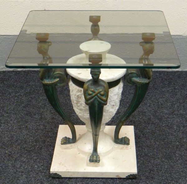 A MODERN SQUARE GLASS TOP COFFEE TABLE on a figural and faux-marble base in the classical Egyptian