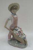 A BOXED LLADRO FIGURE OF BOY GARDNER pushing a wheelbarrow full of flowers, 24cms high