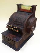 A NATIONAL CASH REGISTER model no.317, in brass and wood, for restoration, 28cms wide