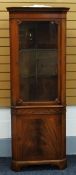 A REPRODUCTION MAHOGANY STANDING CORNER CUPBOARD / CABINET with single glazed upper door and with