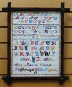 A WOOL ALPHABETIC SAMPLER by Ann Louise Evans, aged twelve of Dolforwyn School, (Powys) 1881-1882,