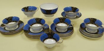 A CROWN STAFFORDSHIRE TEA-SET of thirty-one pieces and decorated with panels of gilded Oriental-