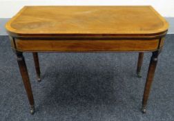 A FOLDOVER TEA TABLE inlaid mahogany and on tapered supports, 90cms wide