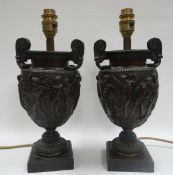A PAIR OF BRONZE TABLE LAMPS on square platform bases and in the form of Classical twin-handled