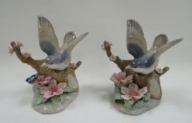 THREE BOXED LLADRO GARDEN BIRDS each perched on branches, 11cms high