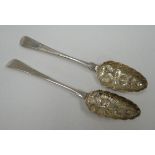 A PAIR OF GEORGE III SILVER BERRY SPOONS having heraldic engraved terminals, feathered stems and