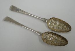 A PAIR OF GEORGE III SILVER BERRY SPOONS having heraldic engraved terminals, feathered stems and