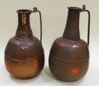 A PAIR OF COPPER PRIMITIVE WATER VESSELS with sgraffito decoration to the long necks and long fitted