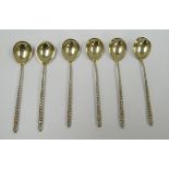 A SET OF SIX RUSSIAN SILVER COFFEE SPOONS the pear shaped bowls decorated in relief with a floral