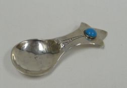 AN ARTS & CRAFTS SILVER CADDY SPOON BY ALBERT EDWARD BONNER with floral splayed terminal and
