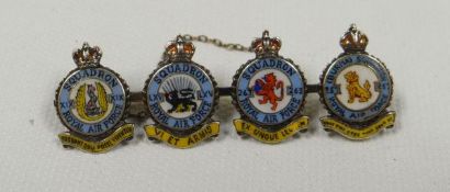 AN ENAMEL & WHITE GOLD RAF BROOCH composed of four circular squadron coat-of-arms with titles, Latin