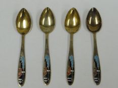 A SET OF FOUR RUSSIAN ART DECO SILVER GILT & ENAMEL TEA SPOONS the terminals enamelled with stylised