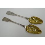 A PAIR OF GEORGE III SILVER BERRY SPOONS with monogrammed and foral chased terminals and raised