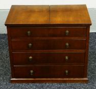 A MINIATURE CHEST OF DRAWERS in mahogany with four graduated drawers bearing brass knobs, 50 x