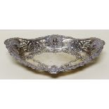 A SILVER BASKET of near oval form and wit open work and repousse decoration including lion heads,